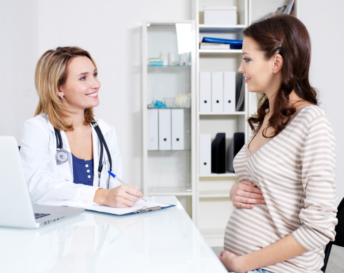 Pregnant girl at the doctor in the clinic