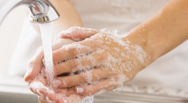 Caucasian woman washing her hands