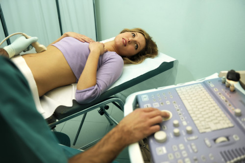 Doctor using ultrasound machine