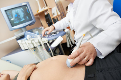 Doctor with ultrasound equipment during ultrasound medical examination