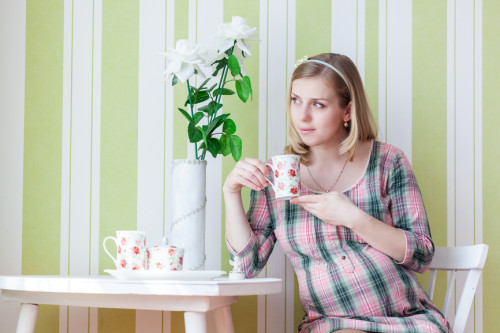 Pregnant woman is drinking tea