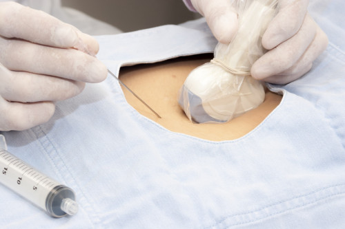 Doctor scanning of a stomach of pregnant woman