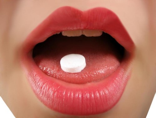 woman takes a pill