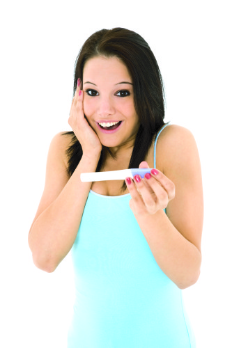 Young Caucasian woman looking at pregnancy test