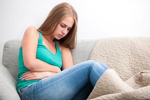 Woman having abdominal pain, upset stomach or menstrual cramps