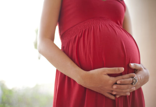 Image of pregnant woman touching her belly with hands; Shutterstock ID 111643082; PO: The Huffington Post; Job: The Huffington Post; Client: The Huffington Post; Other: The Huffington Post